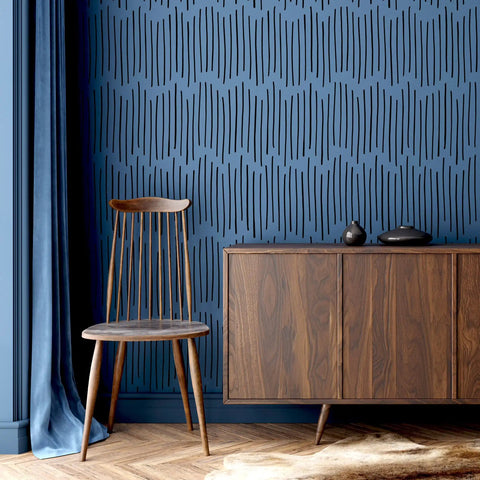 DIY Friendly Ink Lines Geometric Wall Stencil Set 2 Pack 17x39 Inches for easy accent walls in a modern room with a chair and cabinet.