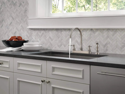 Windemere Brushed Nickel Kitchen Faucet With Side Sprayer Four Hole 8 Inch Center Installation shown in a modern kitchen.