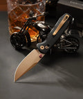 Dope Rose Gold Folding Knife with 3-Inch 14C28N Steel Blade with PVD Coating and Crossbar Lock against motorcycle model