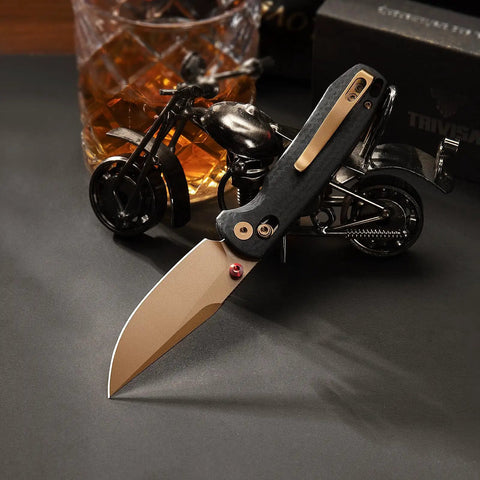 Dope Rose Gold Folding Knife with 3-Inch 14C28N Steel Blade with PVD Coating and Crossbar Lock against motorcycle model