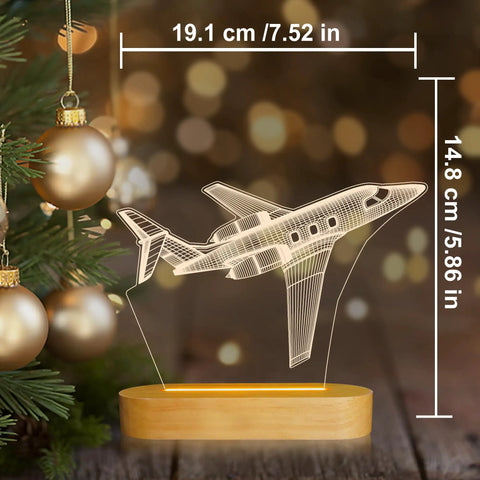 Lit 3D Airplane Illusion Night Light With Dimmable LED Wood Base next to Christmas tree, USB Powered Desk Lamp