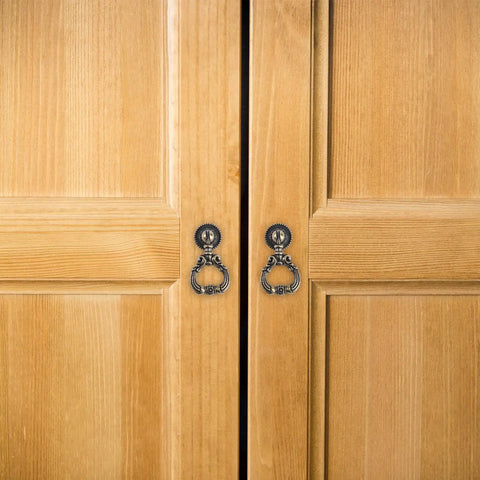 Retro Zinc Alloy Pull Ring Cabinet Handles 4 Pack For Cabinets And Cupboards on wooden door, 59mm, vintage design.