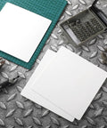 Top Shelf Six Pack White Ceiling Cover Plates 12 Inch Wall Hole Covers on a metal work surface with tools.