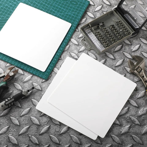 Top Shelf Six Pack White Ceiling Cover Plates 12 Inch Wall Hole Covers on a metal work surface with tools.