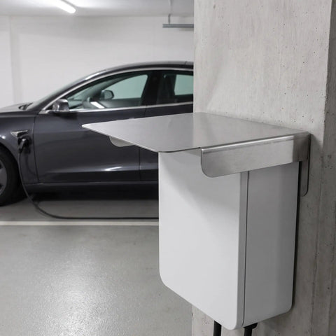 Heavy Duty EV Charger Protective Housing With Waterproof Outdoor Box Cover Built From Rock Solid Stainless Steel mounted beside a car.