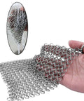 Close-up of Cast Iron Scrubber With Stainless Steel Chainmail, 8x6 Inch Skillet Cleaner For Preseasoned Pans, in a hand.