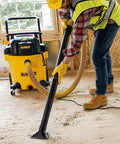 No Bull Heavy Duty 16 Gallon Wet Dry Shop Vacuum With 6.5 Peak Horsepower And 116 Cfm Airflow in use, clearing debris on a job site.