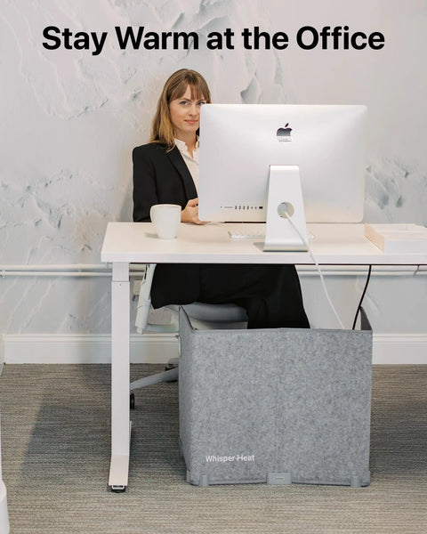 Woman using Silent Personal Warmer with Thermostat under desk, energy efficient for warm legs and feet in office setting.