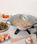 Electric Wok With 1500 Watt Heating Stainless Steel Body Aluminum Clad Base For Fast Even Heating on countertop with food