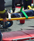 Color Coded Backboard Spine Board Straps For Quick Immobilization On Stretcher 10 Point System Industrial Grade Nylon Spider Straps For EMS Pros And Medical Teams in use by emergency responders on a stretcher.