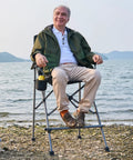 Man sitting on Tall Camping Directors Chair With Cup Holder 31 Inch Bar Height Folding Chair For Outdoors by lake