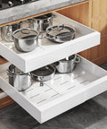Set Of Two White Pull Out Cabinet Organizer Shelves holding multiple stainless steel pots in a kitchen drawer.