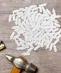White Shutter Repair Pins, 120 Piece Movable Louver Fasteners scattered on a wooden surface next to a hammer and measuring tape.