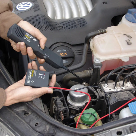 Hands using Automotive Wire Tracker Pro with Short and Open Circuit Finder and Cable Toner for DC 6 to 42V in car engine