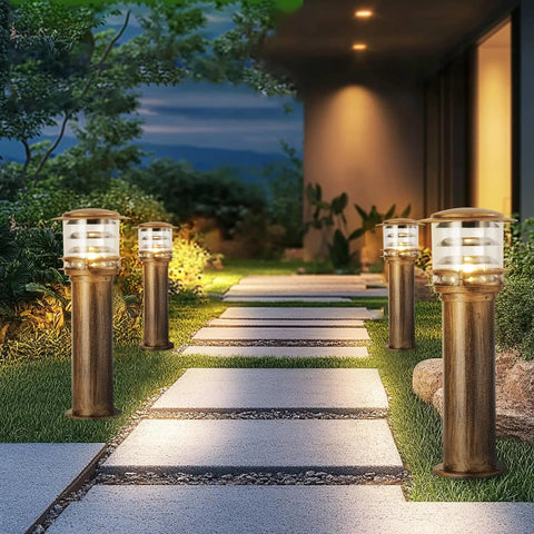 Weatherproof Aluminum Post Cap Lights For Deck And Yard With Bright Acrylic Diffuser illuminating a stone pathway in a garden.