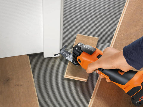 Fein Starlock Plus oscillating multi-tool (orange) cutting wood with attached metal saw blade