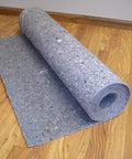Pro Grade Flooring Underlayment Roll For Laminate Wood And Tile Sound Dampening Padding Compression Resistant Mat For Floating Glue Down Install Covers One Hundred Square Feet in a room.