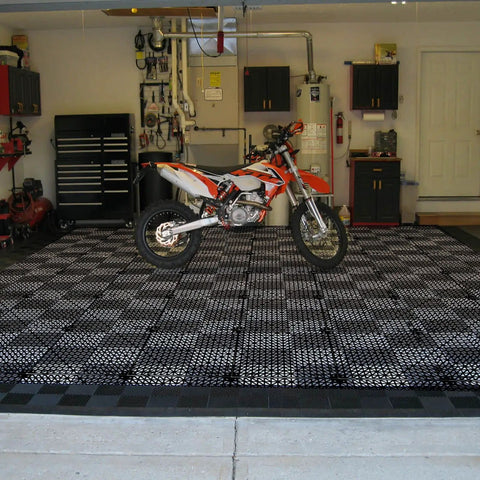 12 Pack Interlocking Floor Tiles 11.8 Inch By 11.8 Inch Rubber Mats For Wet Areas Grippy No Slip Drainage in a garage with bike