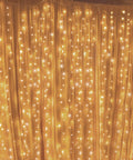300 LED Curtain String Lights With 8 Modes Plug In Fairy Lights installed indoors, 6.6ft x 9.8ft warm white glow for bedroom.
