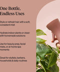 Hand holding Ultra Fine Continuous Spray Bottle For Hair And More With Even Mist For Styling, next to green plant