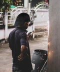 Person welding in yard wearing Reversible Welding Cap For Men And Women, Washable Fireproof Welders Hat With Flame Retardant Cotton
