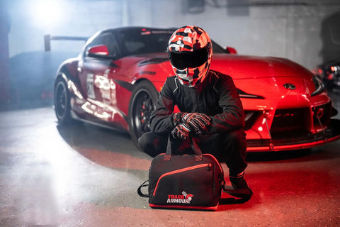 Racer with helmet near car, holding Fleece Lined Motorcycle And Racing Helmet Bag With Hidden Shoe Compartment Waterproof 600D Oxford Gear Carrier.