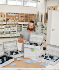 Person organizing Garnet 5 Inch 125mm Abrasive Sheets GR Set in Systainer Case for VOC varnishes and hard surfaces.