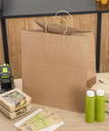 Large Kraft Paper Gift Bags With Handles 100 Pack Brown Eco Friendly Grocery Shopping Retail Takeout Bags on counter