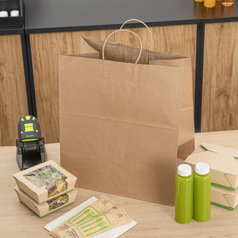 Large Kraft Paper Gift Bags With Handles 100 Pack Brown Eco Friendly Grocery Shopping Retail Takeout Bags on counter