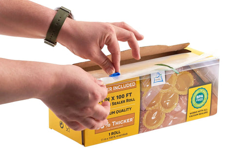 Hands using the cutter on 11 inch by 100 foot vacuum sealer bags rolls with dispenser cutter, BPA free 4 mil thick, in a box.