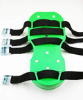 Close-up of green 6.8 cm lawn aerator spike shoes with heavy duty buckles and four adjustable straps.