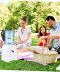 Family using Tabletop Water Dispenser Cooler For Home Office And Outdoor Use during a picnic