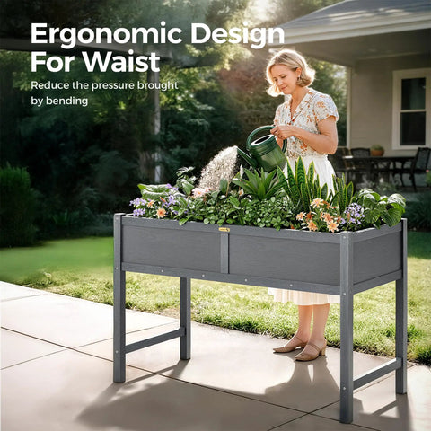 Woman using HDPE Elevated Raised Garden Bed With Legs For Outdoors 47 X 22 X 30 Inches Planter Box on patio with flowers and herbs