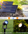 Solar Powered Cast Aluminum Warm White LED Spotlight For Outdoor Garden Yard Landscape Trees Uplight And Downlight With Waterproof Build And Separate Solar Panel With Sixteen Point Four Ft Cable Auto Five To Eight Hour Night Lighting, showing solar panel and two spotlights in a garden.