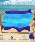 Oversized Beach Blanket 78 By 81 Inches Go-To Picnic Mat for 4 to 7 Adults waterproof and sandproof in blue, held on a beach.
