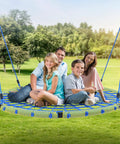 Family enjoying a 60 Inch Spider Web Saucer Tree Swing for Kids and Adults Heavy Duty Outdoor Net Swing in park setting.