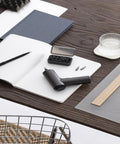 Cordless Screwdriver With USB C Charging, 3.6V 2000mAh Battery on desk, includes 12 S2 steel bits in a box, placed next to a notebook.