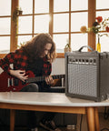 20 Watt Portable Electric Guitar Amplifier With Headphone Input And Gain Control For Quiet Practice Or Onstage Jams near guitarist at home.