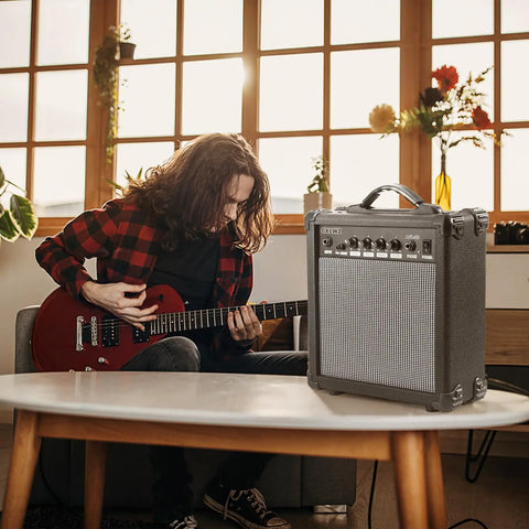 20 Watt Portable Electric Guitar Amplifier With Headphone Input And Gain Control For Quiet Practice Or Onstage Jams near guitarist at home.