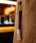 Grinder Cleaning Brush Set With Walnut Wood Handle And Natural Bristles For Espresso Machines And Home Baristas hanging on apron