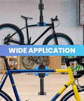 Wall Mounted Bicycle Repair Stand With Adjustable Clamp holding road and mountain bikes in a garage setting