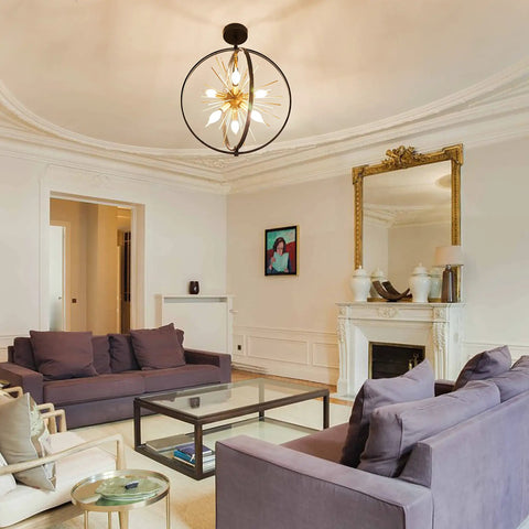Living room with Modern Sputnik Style 6 Light Starburst Chandelier, 18-Inch Globe Fixture In Black And Gold hanging from ceiling.