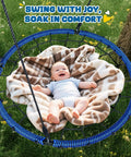 Heavy Duty 40 Inch Spider Web Saucer Tree Swing For Kids And Adults Outdoor Net Swing With Included Straps 750 Pound Capacity Blue Patented Design For Backyard Fun with baby resting comfortably in the swing