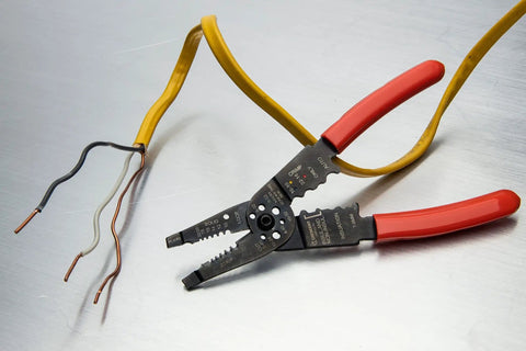 8 Inch Heavy Duty Wire Stripper Cutter Pliers With Dipped Cushioned Grips on wires, demonstrating effectiveness in stripping 10 to 22 AWG