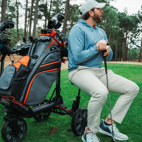 Electric Golf Push Cart With Roomy Seat Featuring Full Directional Remote Nine Speed Levels Mileage Counter Screen And Trueline Tracking for lounging golfer.