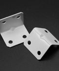 12 Pack White Powder Coated Steel L Corner Braces With Phillips Screws, right angle joinery plates close-up on black background.
