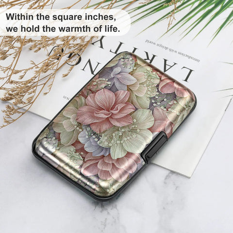 Ultra Slim RFID Blocking Aluminum Card Wallet For Men And Women with floral design, on a magazine and foliage background.