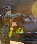 Hunter using Scent Safe Deluxe Travel Scent Bag For Hunting Gear And Clothing Keeps Your Scent Hidden And Your Gear Scent Free On The Go