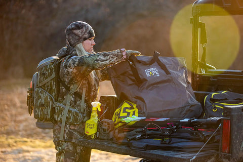 Hunter using Scent Safe Deluxe Travel Scent Bag For Hunting Gear And Clothing Keeps Your Scent Hidden And Your Gear Scent Free On The Go