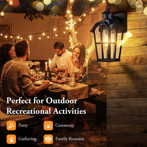 Two Pack Motion Sensor Outdoor Wall Lights Dusk To Dawn Waterproof Exterior Lanterns For Porch Garage Doorway And Backyard Black Finish With Wide 220 Degree Detection And Up To 40 Feet Range illuminating a backyard dinner setting.
